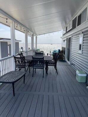 Outdoor dining - Coastal Chic Back Bay Waterfront Tiny Home Steps Away From Sandbridge Beach (Virginia Beach)