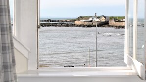 Habitació amb vistes al mar, una finestra i un radiador.