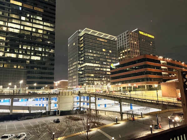 A nighttime cityscape with modern buildings, including a Wells Fargo and a Microsoft building. - Perfect 3-bedroom townhome in Atlantic Station! (Atlanta)