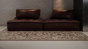 A modern interior with a dark wall, two illuminated wall sconces, and a brown leather sofa with a patterned rug. - PREMIUM DOO Hostel (Tashkent)
