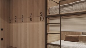 A bunk bed with a wooden wall and numbered room doors. - PREMIUM DOO Hostel (Tashkent)