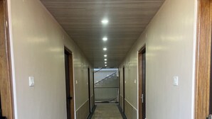 A hotel corridor with a marble floor, wooden doors, and a staircase at the end. - Your home away from home in mountains / 1-bedroom bed & breakfast (Rampur)