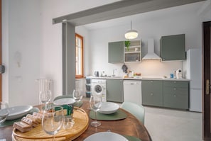 A modern kitchen with a built-in washing machine, a microwave, and a sink. - Sundara Apartment - Two Bedroom Apartment, Sleeps 6 (Poggibonsi)