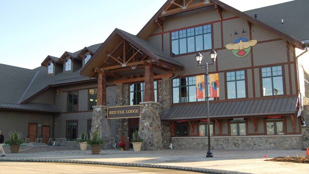 A lodge with a stone facade, wooden beams, and a sign reading 'RED TAIL LODGE.' - Spacious 3 bed 2 bath Sanctuary (Vernon Township)