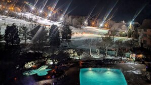 A nighttime view of a resort with a pool, ski slope, and illuminated buildings. - 2 Bed Top Flr Prem Penthouse Suite (Vernon Township)