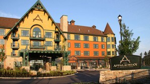 A multi-story building with a prominent entrance, a sign reading 'The Appalachian at Mountain Creek,' and a stone pathway leading to the entrance. - Lodge style getaway 50 miles from NYC patio 207 (Vernon Township)