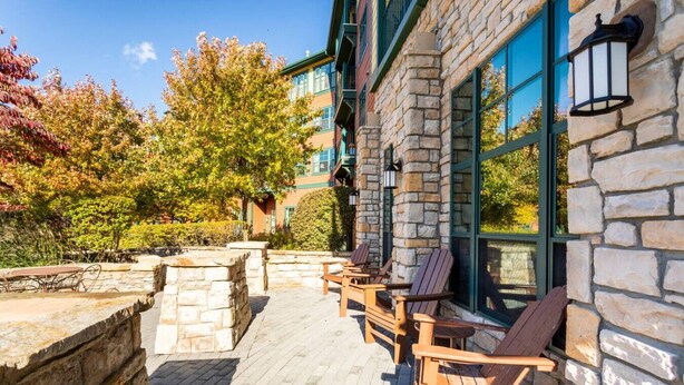 A stone building with large windows and outdoor seating. - Lodge style getaway 50 miles from NYC patio 207 (Vernon Township)