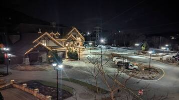 A well-lit building with a driveway and parking area.