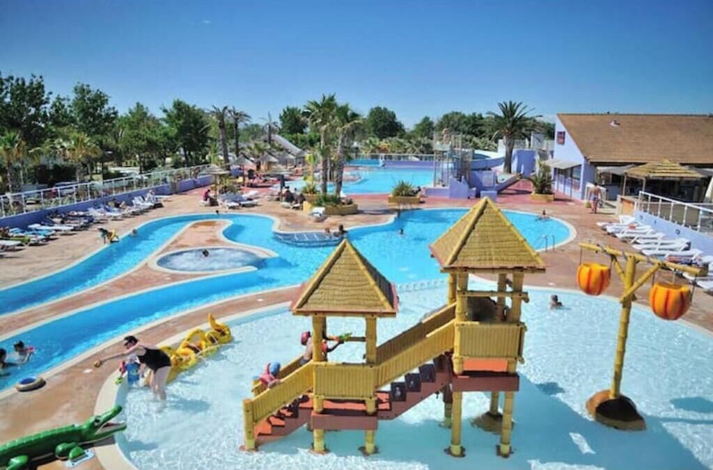 A water park with multiple pools, slides, and play structures.