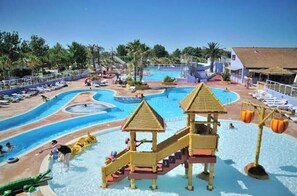 A water park with multiple pools, slides, and play structures. - Family mobile home Camping 5* Le Marisol (Torreilles)