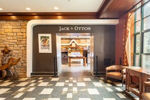 A hotel lobby with a checkered floor, a stone wall, and a Jack & Ottos sign. - Appalachian TOP 4TH FLOOR Studio+ w/amazing views! (Vernon Township)