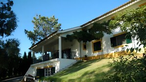 A modern house with a stone foundation, a sloped roof, and a covered porch.