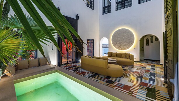 A modern interior with a pool, a sofa, and a patterned floor. - Incredible RIAD in the heart of the Medina (Marrakech)