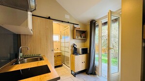 Een moderne keuken met een ingebouwd spoelgedeelte, een magnetron en een koffiezetapparaat.