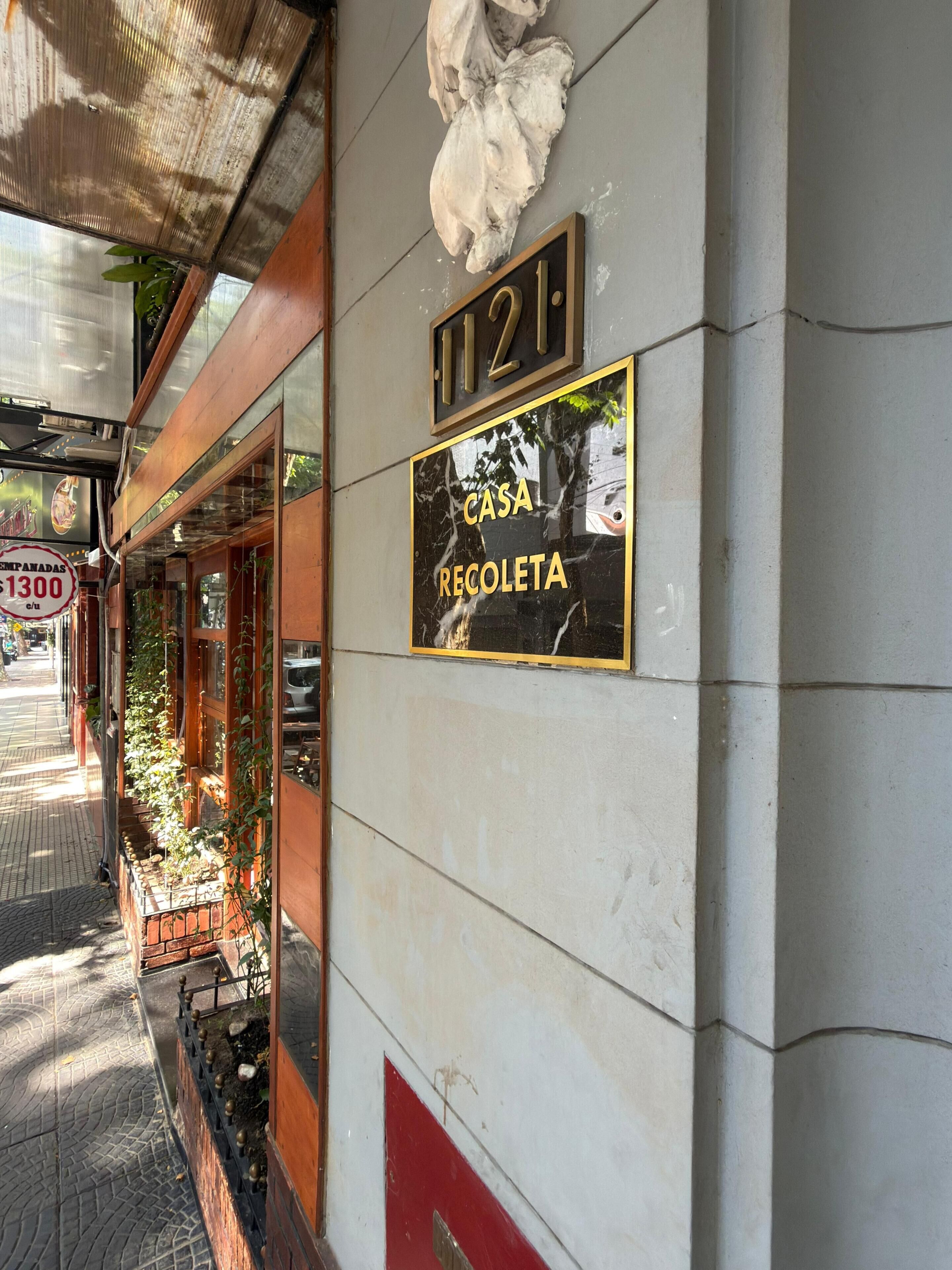 A building with a sign reading "CASA RECOLETA" and a number "1121".