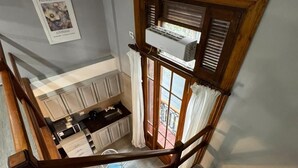 Una escalera con barandilla de madera que conduce a un rellano en el segundo piso.