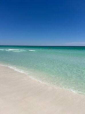A beach with clear turquoise water and a sandy shore. - Heated Pool, Hot Tub & Fire Pit | Walk to Beach (Destin)