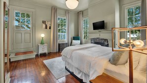 A bedroom with a bed, a television, a window, and a door. - The Treehouse Walk to Forsyth, Balcony (Savannah)