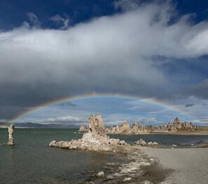 A coastal landscape with rock formations and a rainbow. - Alpine Escape, Cool Pool-Spa, Lakes & Trails Galore, Near Fine Dining / Bars (Mammoth Lakes)