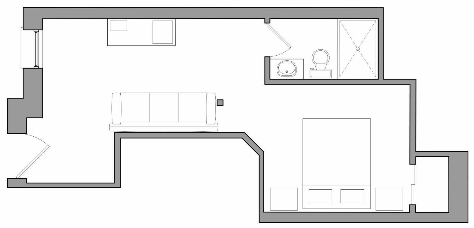 Plano de planta que muestra una cocina, comedor y sala de estar con sofá.