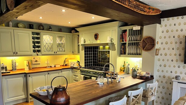 A kitchen with a central island, white cabinetry, and a wooden ceiling. - Countryside Farmhouse - Glasgow - Sleeps 6 (Eaglesham)