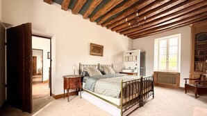 A bedroom with a bed, a nightstand, a dresser, a window, and a bookshelf. - Old Presbytery on the waterfront - pets welcome! (Nanteau-sur-Lunain)