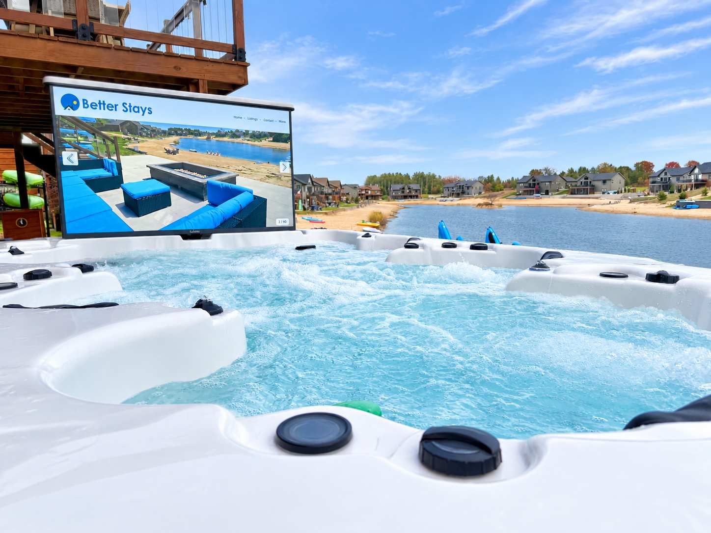 A hot tub with a wooden deck and a screen displaying a property listing.