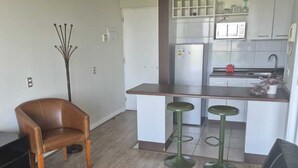 A modern apartment with a living room, a dining area, and a kitchen.