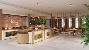 A modern restaurant interior with a central bar, wooden accents, and a view of greenery outside. - NHAAN Resort & Spa Hoi An, Tapestry Collection by Hilton (Hoi An)