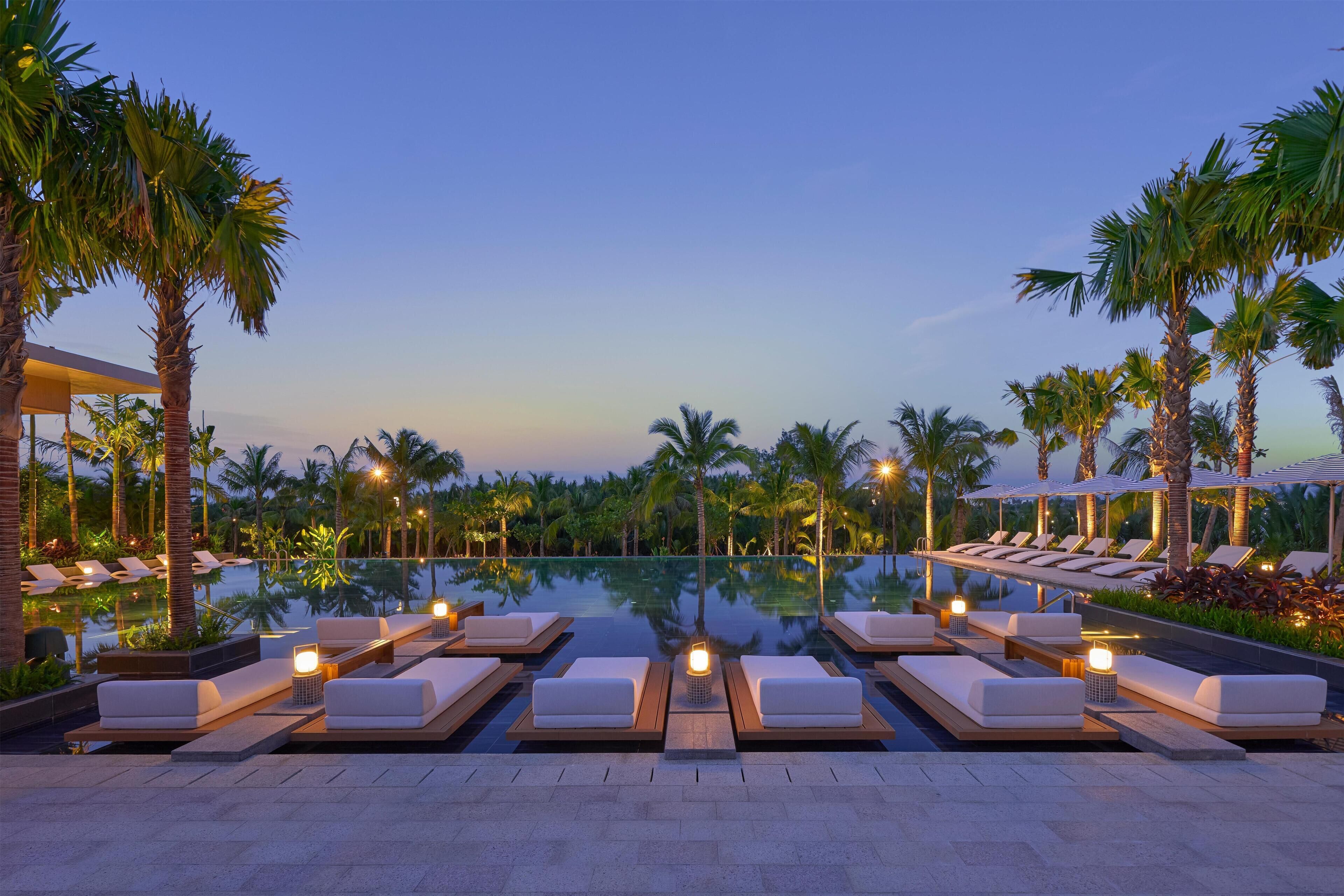 A poolside area with lounge chairs and a clear view of the pool.