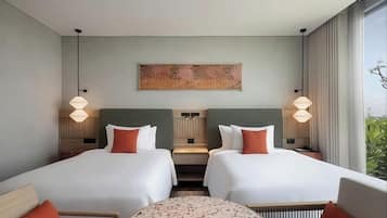 A hotel room with two beds, a round table, and a large window.
