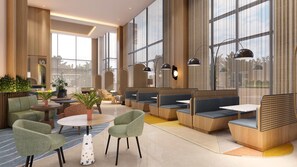 Un área de estar moderna con asientos, mesas y ventanas amplias.