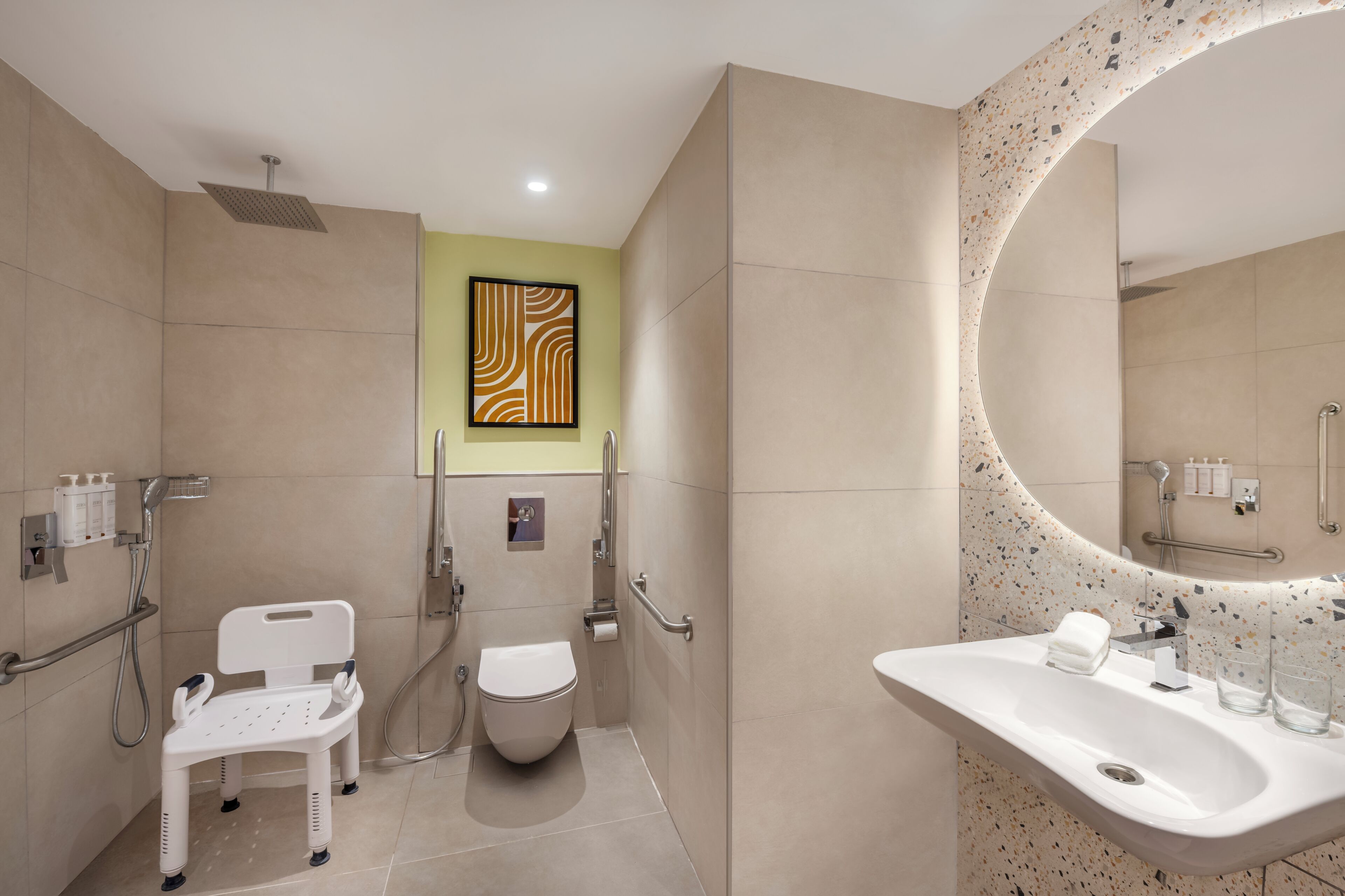 A modern bathroom with a toilet, bidet, shower, and sink.