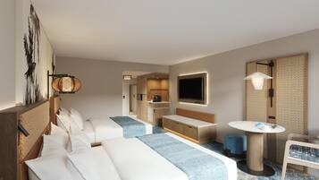 Una habitación de hotel con cama, zona de estar, kitchenette pequeña, televisor y mesa redonda.