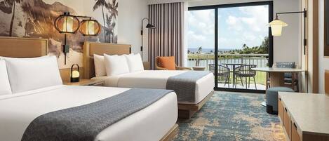 A hotel room with two beds, a balcony with a view, and a dining area.