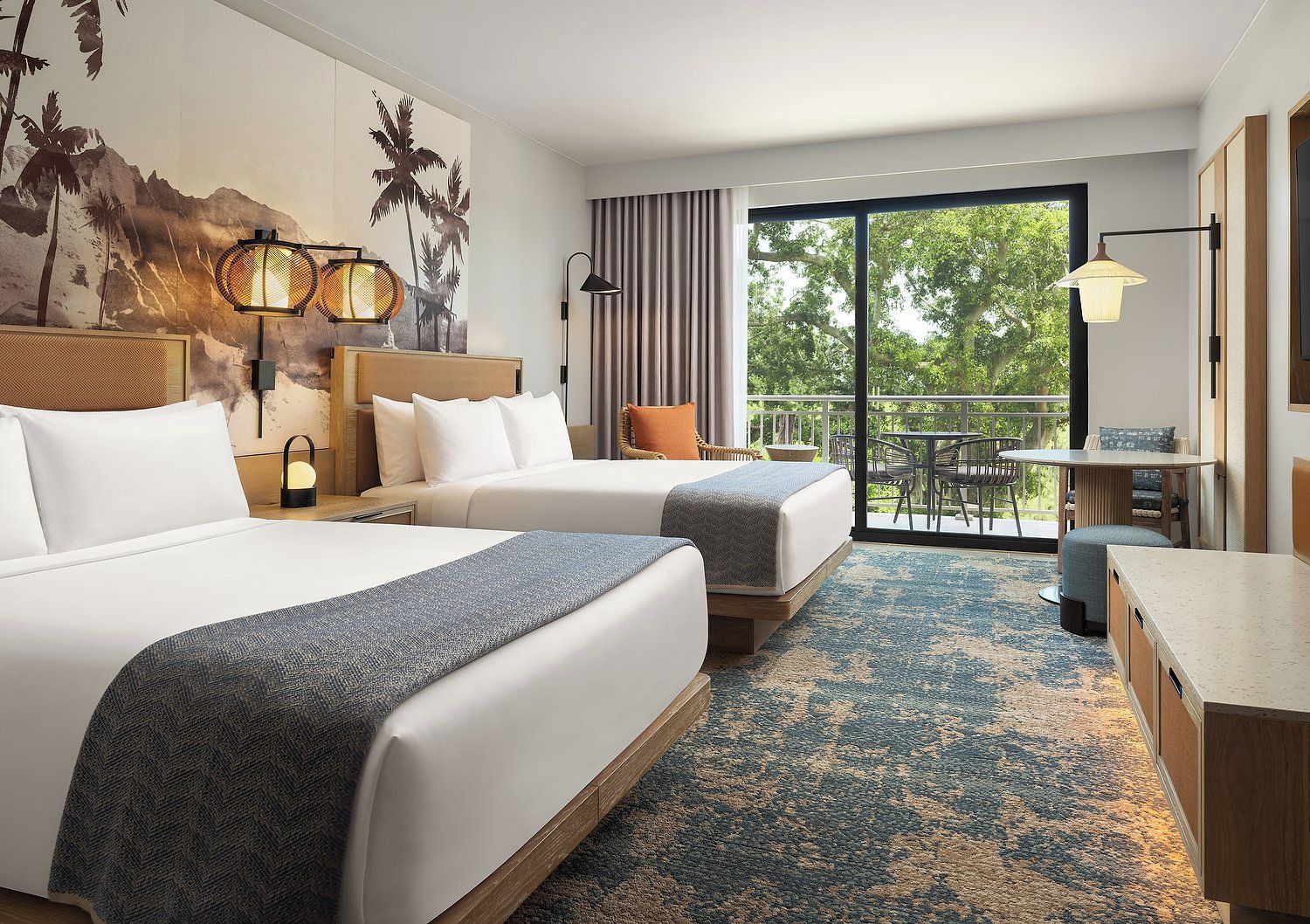 A hotel room with two beds, a balcony with outdoor furniture, and a large window.