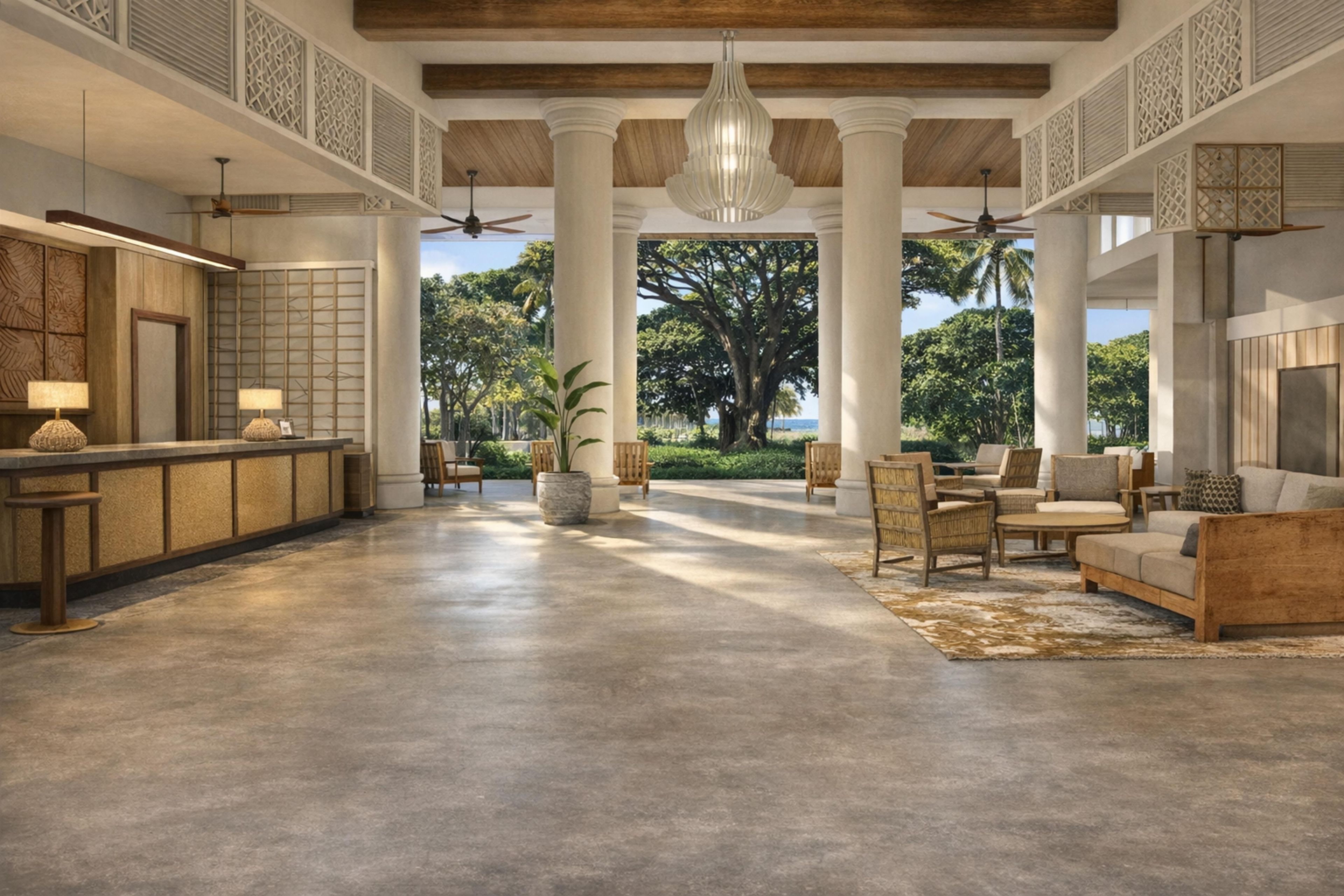 A spacious lobby with a reception desk, seating area, and large windows offering a view of greenery.