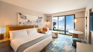 A hotel room with a large bed, a seating area with a table, and a view of the outdoors. - Hale Hokuala Kauai, Curio Collection By Hilton (Lihue)