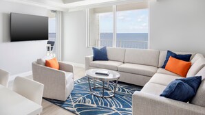 A modern living room with a sofa, armchairs, a coffee table, and a flat-screen TV. - Sunsuites Villas At Sunseeker Resort, Curio By Hilton (Charlotte Harbor)
