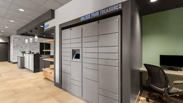A modern office space with a grey filing cabinet labeled 'UNLOCK YOUR TREASURES' and a reception desk with a 'DROP' sign.