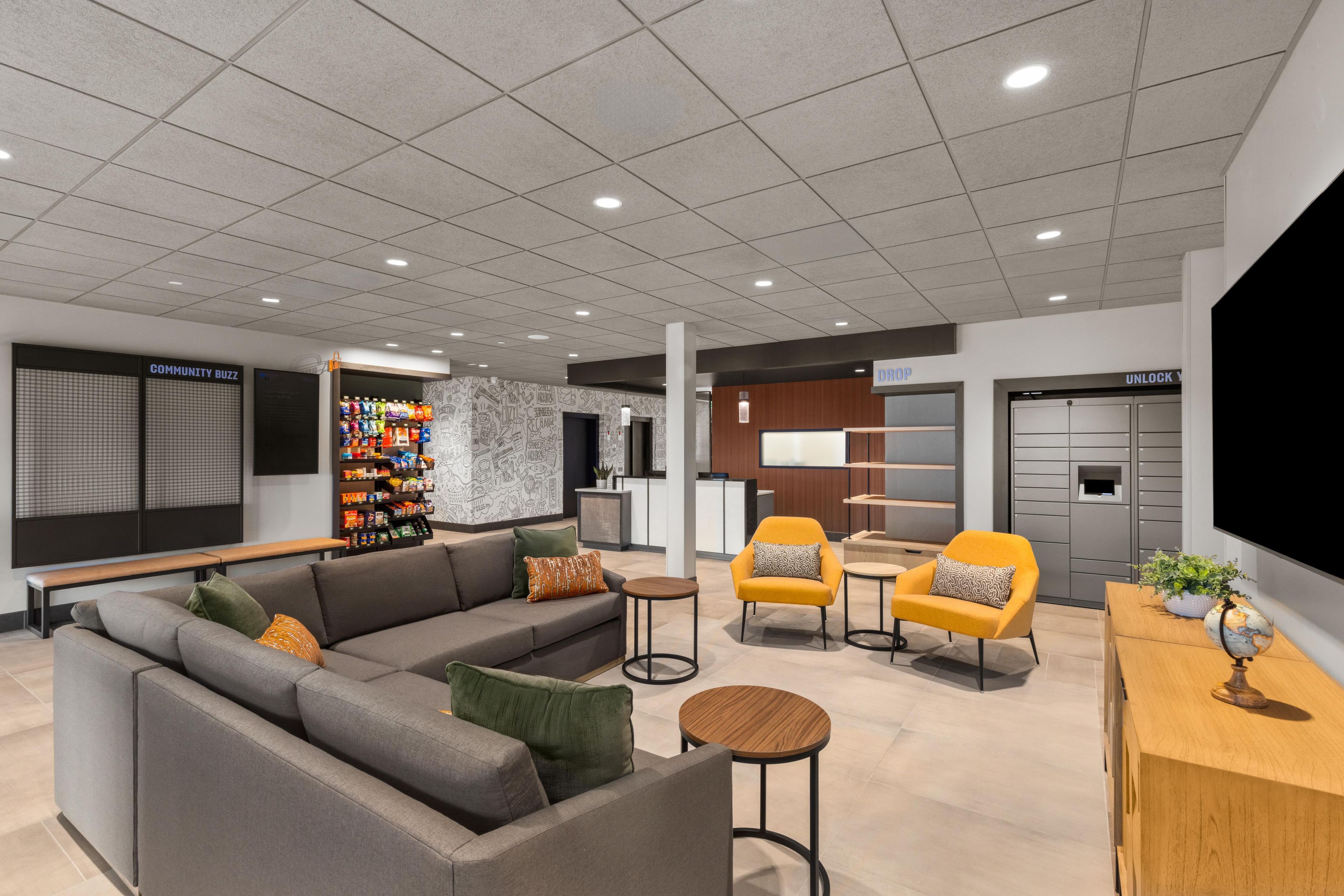 A modern lounge area with a sofa, armchairs, and a small table.