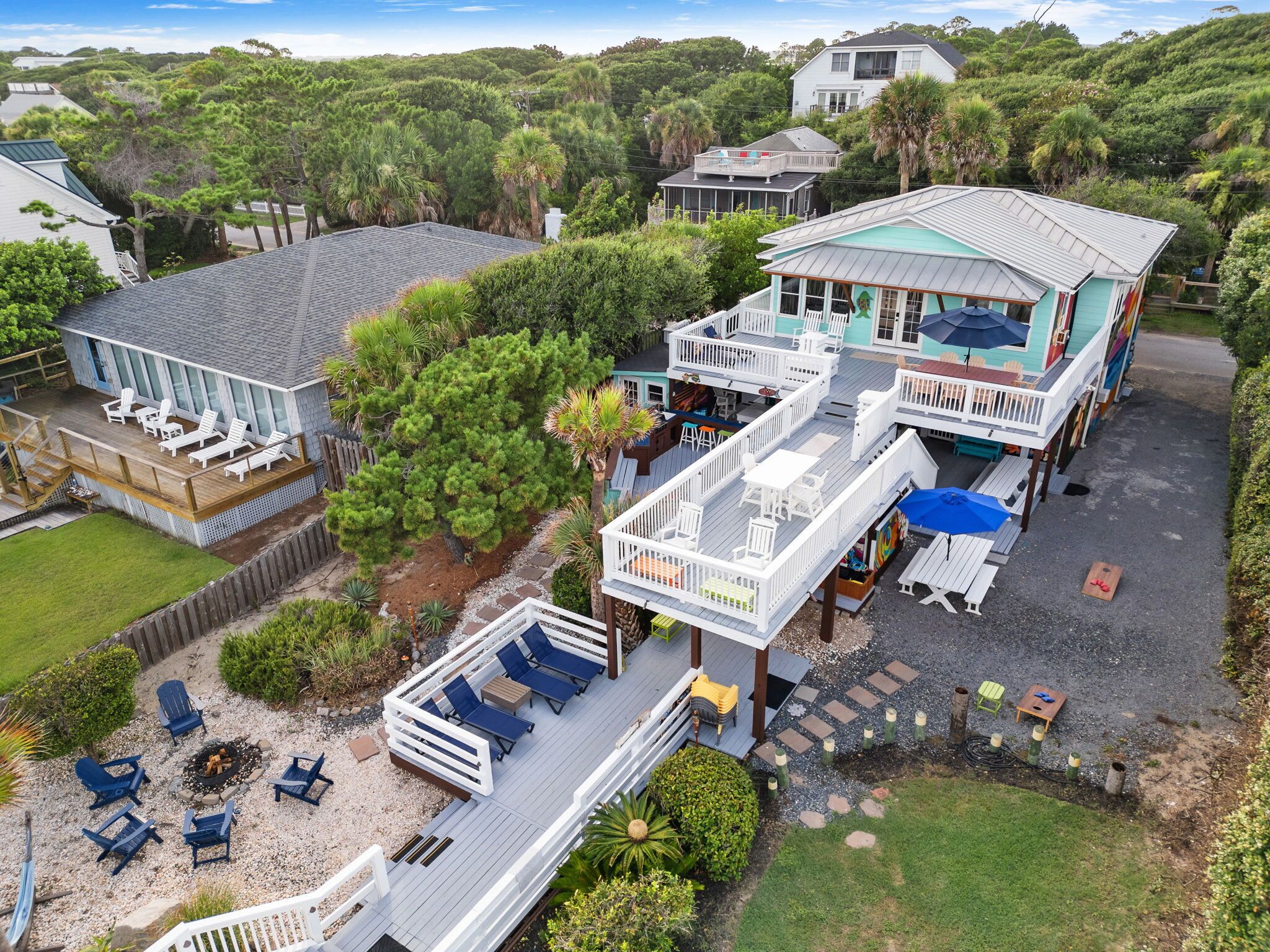 A large house with multiple decks and outdoor seating areas.