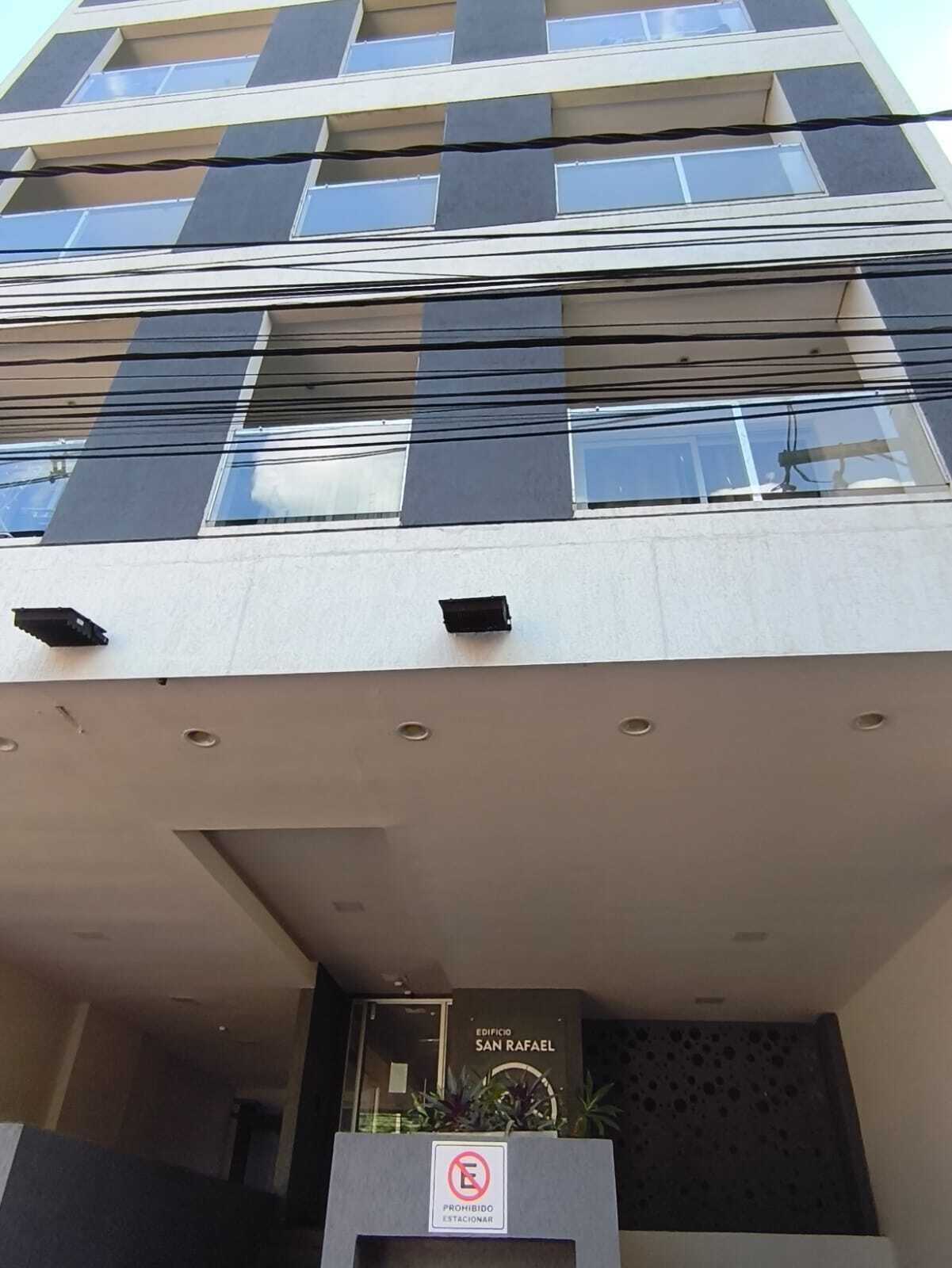 A multi-story building with a sign indicating 'EDIFICIO SAN RAFAEL.'