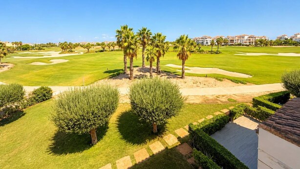 A golf course with sand bunkers, palm trees, and a clear blue sky. - Apartment for 4 people - golf course view - La Torre Golf Resort (Torre-Pacheco)