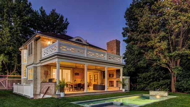 A two-story house with a covered patio, a swimming pool, and a brick fireplace. - EAST HAMPTON VILLAGE JEWEL BOX (East Hampton)