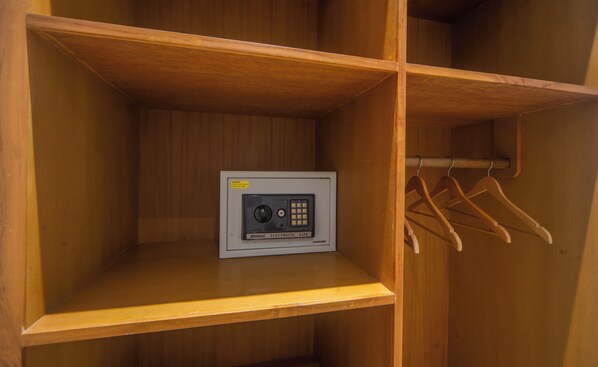 A wooden wardrobe with a built-in electronic safe and a clothing rack. - 3BR Villa White Rose Central Canggu (Canggu)