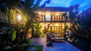 A two-story building with a balcony, outdoor seating, and a pool. - 3BR Villa White Rose Central Canggu (Canggu)