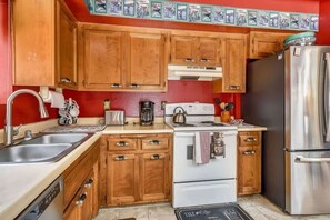 A kitchen with wooden cabinets, a stainless steel refrigerator, a stove, and a sink. - Only 7 miles to Heavenly, Huge Deck, Pets Welcome (South Lake Tahoe)