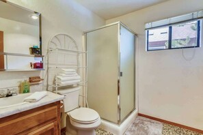 A bathroom with a shower, toilet, and vanity. - Only 7 miles to Heavenly, Huge Deck, Pets Welcome (South Lake Tahoe)