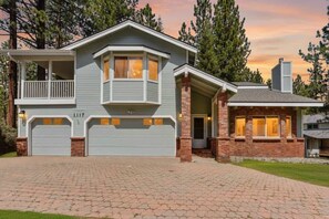 A two-story house with a garage, a balcony, and a chimney. - Minutes to Heavenly, Private Covered Hot Tub (South Lake Tahoe)